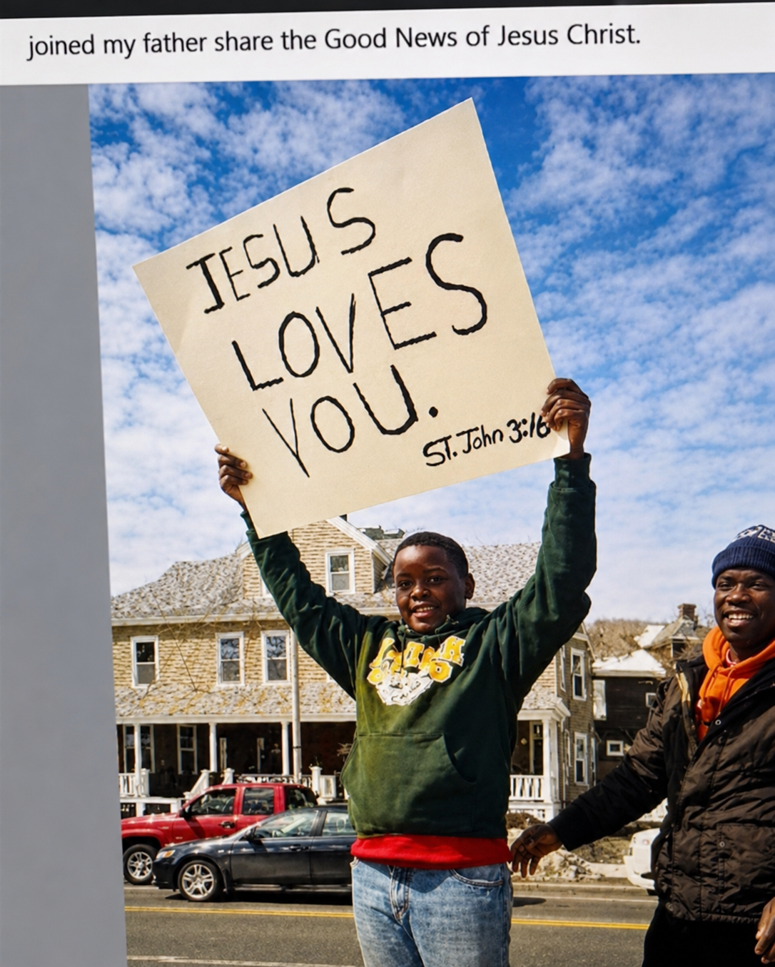 Child holding Jesus Loves You sign — St. John 3:16